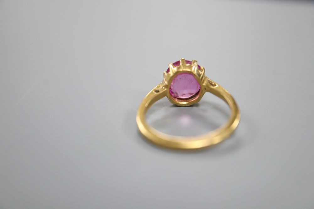 A yellow metal and synthetic? ruby set dress ring, size K/L, gross 4.5 grams.